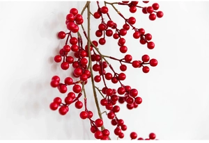 Close-up of vibrant red artificial berry stems for festive Christmas home decoration