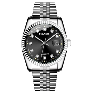 Macro detail of men's steel watch with silver metal strap, black dial and diamond markers