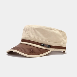 Detail of vintage cotton military cap with leather brim, metal rivets, and star embroidery