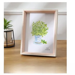 Detail view of 6x8 inch white frame with golden trim on a wooden tabletop setting