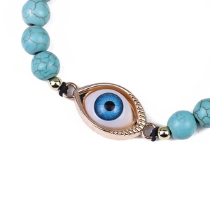 Adjustable woven turquoise beaded bracelet with evil eye charm in golden frame
