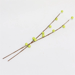Detailed view of light green artificial berry branches with brown textured stems