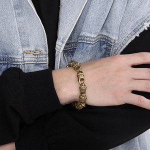 Rock style gold brass Garfield link bracelet for men shown on wrist with denim outfit