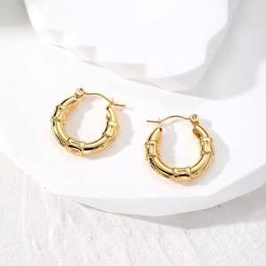 Detailed macro view of golden bamboo textured hoop earrings with secure pin clasp closure