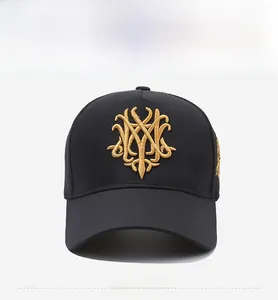 Close-up of the breathable black mesh and gold monogram embroidery on the baseball cap
