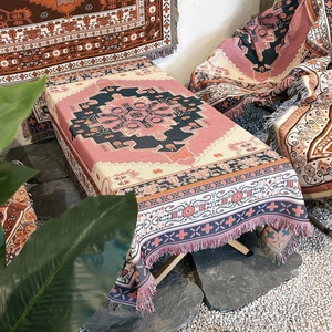 Detail of bohemian outdoor blanket with geometric tribal patterns and fringed edges