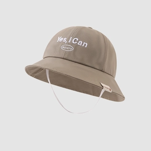 Detail view of khaki cotton bucket hat with white 'Yes, I Can' embroidery and chin strap
