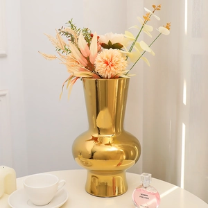 Modern gold mirror finish ceramic vase with artificial carnations for home decor