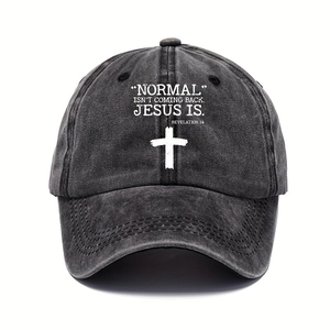 Close-up of washed cotton texture and white religious embroidery on a grey baseball cap