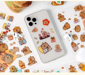 Detailed view of cute Capybara waterproof stickers on a clear iPhone case with DIY charm