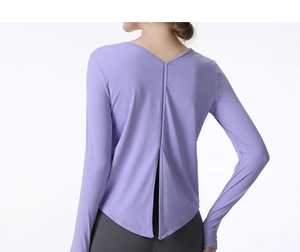 Detail of lavender long sleeve sports top featuring a stylish back slit and V-neckline