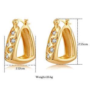 Detailed view of gold plated U-shaped earrings with zircons measuring 2.55cm by 2.12cm