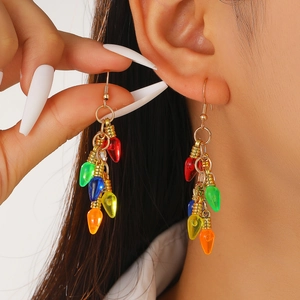 Close-up of creative colorful bulb charms on gold metal Christmas tree earrings