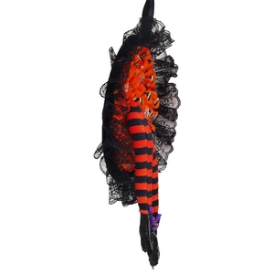 Detail of Halloween witch legs with orange stripes, black lace skirt, and purple bow buckle