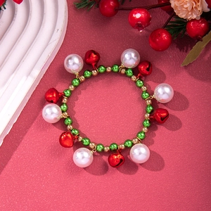 Christmas beaded bracelet with white pearls, red bells and festive green accents