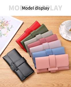 Three-fold PU leather wallets displayed in multiple colors on a wooden surface with a coffee cup