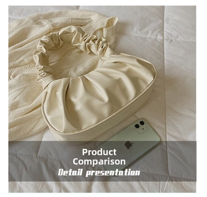 Detailed size comparison of the cream pleated cloud bag next to a smartphone