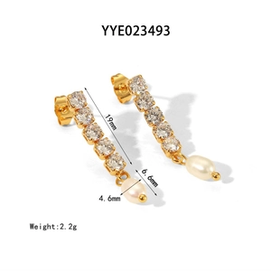 Macro view of gold tassel earrings with six zircons and a baroque freshwater pearl