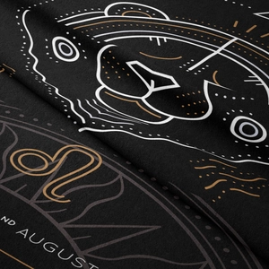 Detail of Leo zodiac tapestry fabric showing August text and lion pattern texture