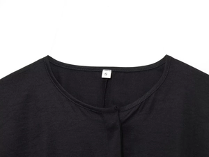 Detail view of the black blouse neckline with white size S label and neat stitching