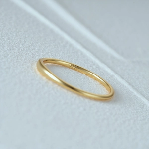 Macro shot of 925 sterling silver ring showing the S925 hallmark on polished gold surface