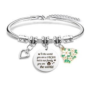 Detailed macro of silver snake chain bracelet with heart and daisy pendants for MOM