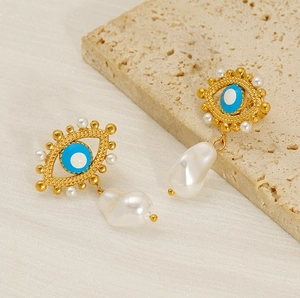 Detail of evil eye stud earring with small white pearls and baroque pearl drop