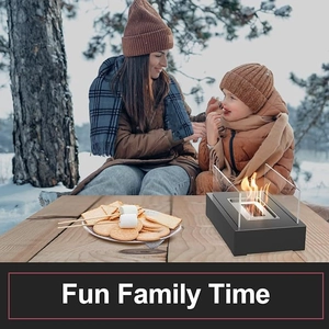 Cozy family time roasting marshmallows over a portable rectangular tabletop fire pit in snow