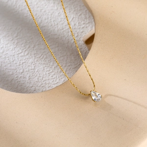 Elegant 18K gold plated titanium necklace with teardrop zircon pendant on minimalist stand