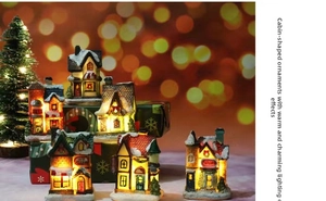 Detailed view of LED resin Christmas village houses with warm glowing light and snow
