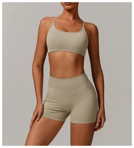 Front view of seamless ribbed light green sports bra and high-waisted fitness shorts
