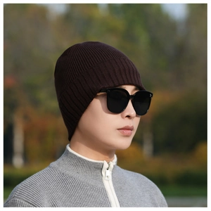 Close-up of deep brown rib-knitted beanie with fine texture for cold winter warmth