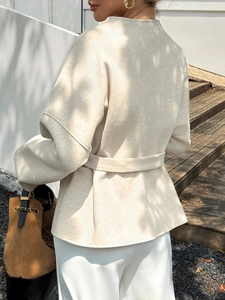 Women's beige short wool blazer jacket with waist belt shown from back and side view