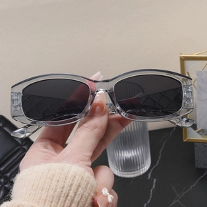 Detail showing grey transparent frame and quilted texture on the oval sunglasses
