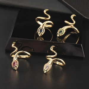 Set of four gold snake rings with colorful zircon gemstones and adjustable wrap design