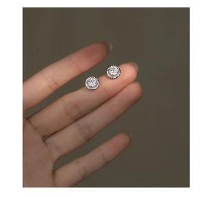 Detailed macro view showing the actual size of classic silver round halo stud earrings