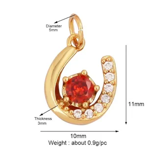 Macro detail of horseshoe pendant with red zircon and white diamond embellishments