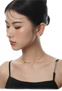 Detail of S925 silver pearl necklace with sparkling zircon on a female model