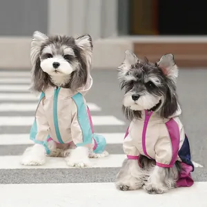 Waterproof hooded dog raincoat in blue and magenta patchwork for outdoor use