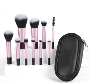 Macro view of 10-piece portable makeup brush set with a black zippered travel pouch