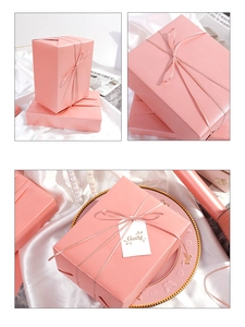 Macro shot of pink pearlescent wrapping paper with matching silk ribbon and gift tag