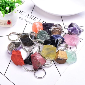 Macro shot of assorted natural raw crystal keychains including amethyst and rose quartz