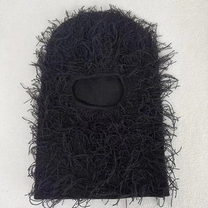 Macro detail of black knitted balaclava mask with unique shaggy fringe texture