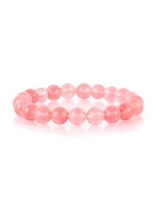 Macro detail of natural pink stone beaded bracelet with polished round crystal beads