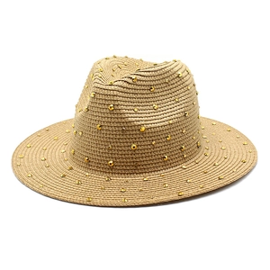 Straw Panama hat in khaki featuring metallic cone studs and wide brim sun protection