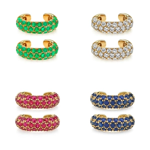 Detail view of gold ear cuffs featuring pave-set green, blue, pink, and clear zircons