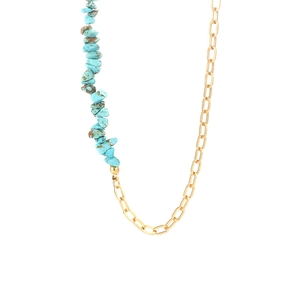 Detail of bohemian turquoise stone and golden stainless steel asymmetrical necklace