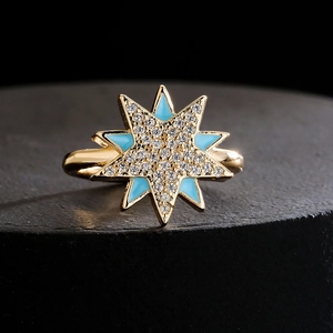 Golden starburst open ring with blue enamel and sparkling pave zircon crystals
