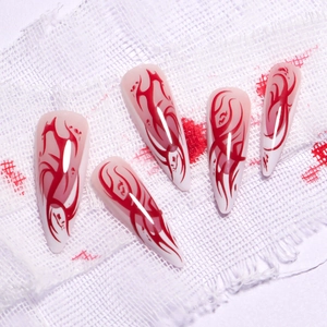 French long stiletto fake nails with red flame ombre design on white base for Halloween