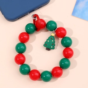 Close-up of beaded Christmas phone wrist strap with red green beads and a tree charm